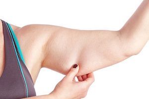 woman pinching arm fat